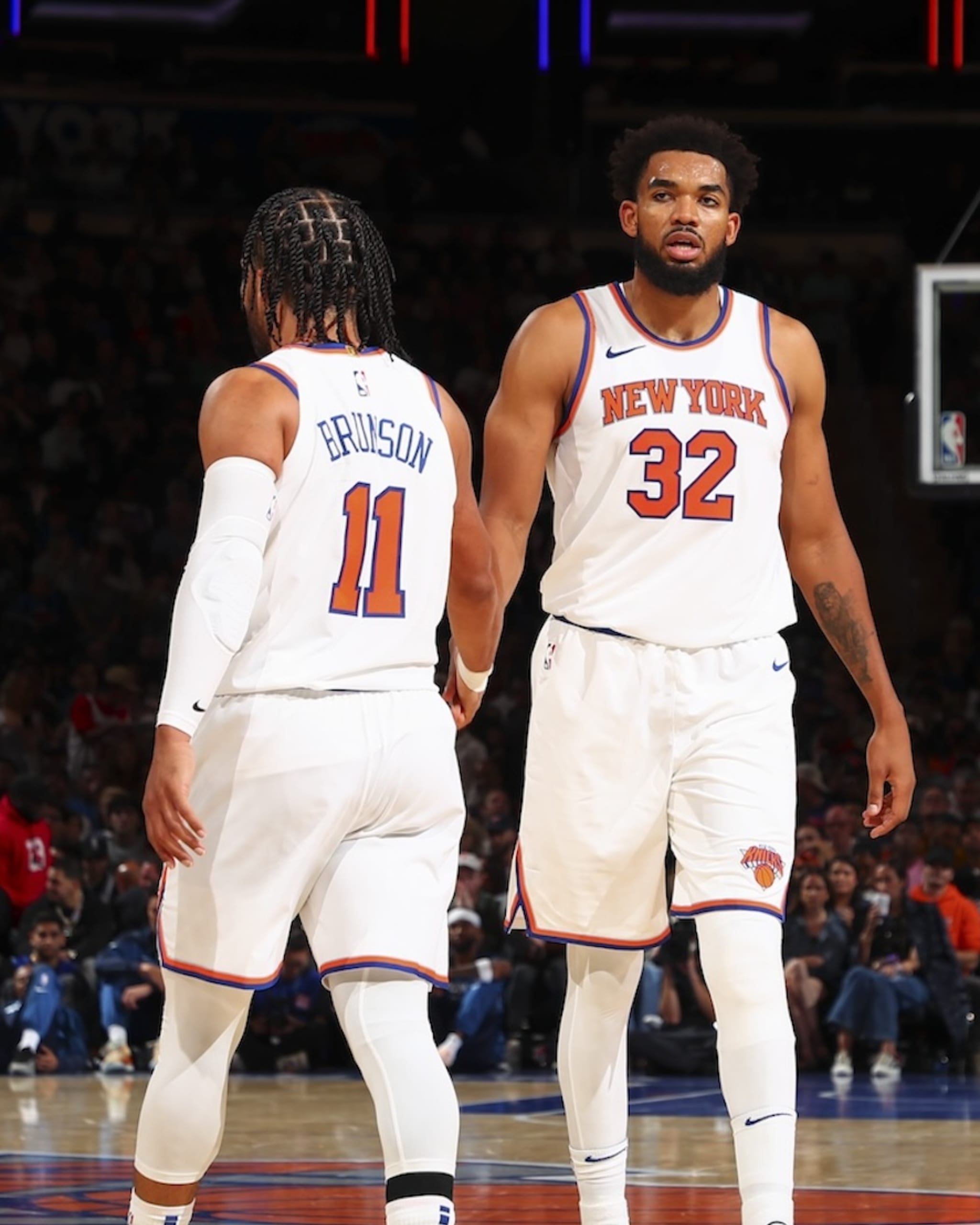 NEW YORK, NY - OCTOBER 13: Karl-Anthony Towns #32 of the New York Knicks high-fives teammate Jalen Brunson #11 during the game on October 13, 2024 at Madison Square Garden in New York City, New York. 